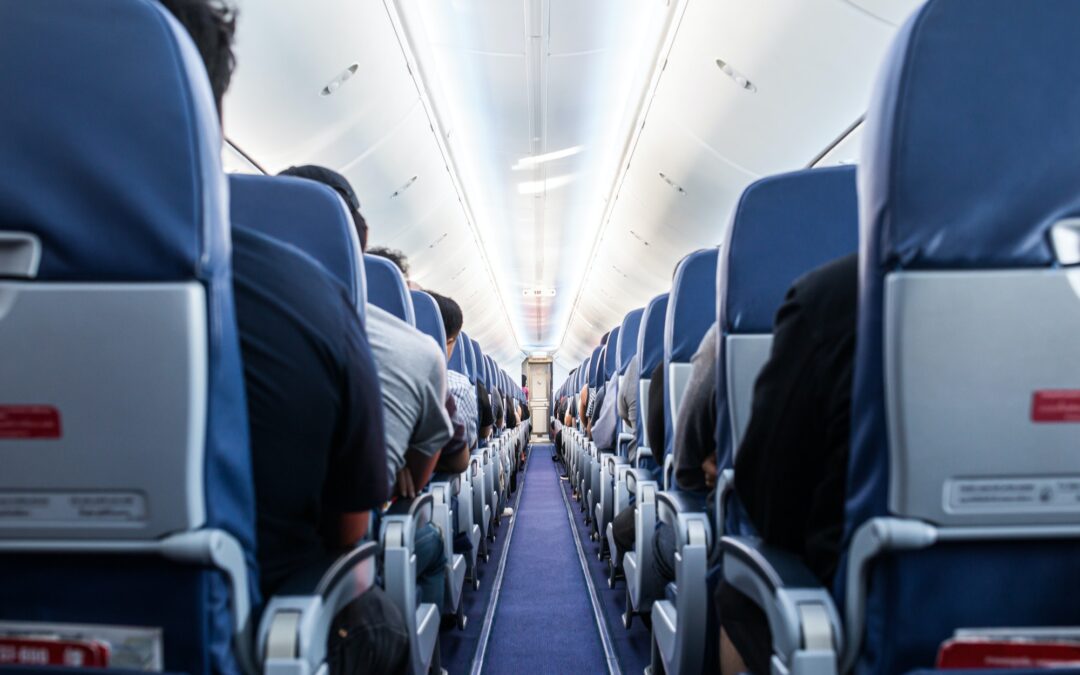 Passengers traveling by a plane, shot from the inside of an airplane