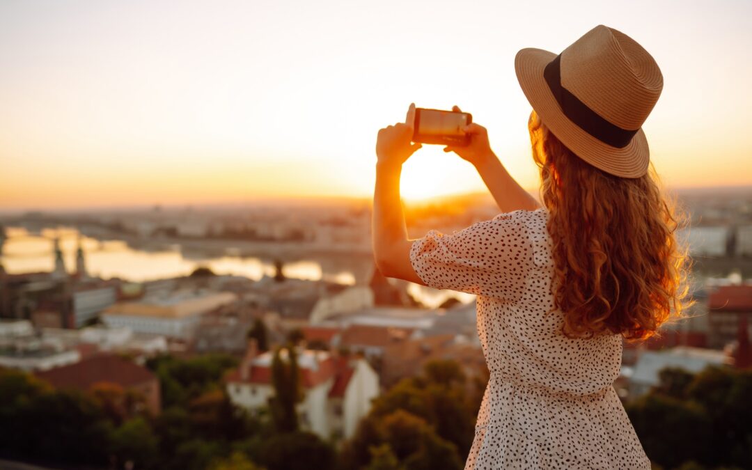 Travel in Europe. Young woman enjoys sunrise. The concept of travel, tourism, vacation and freedom.